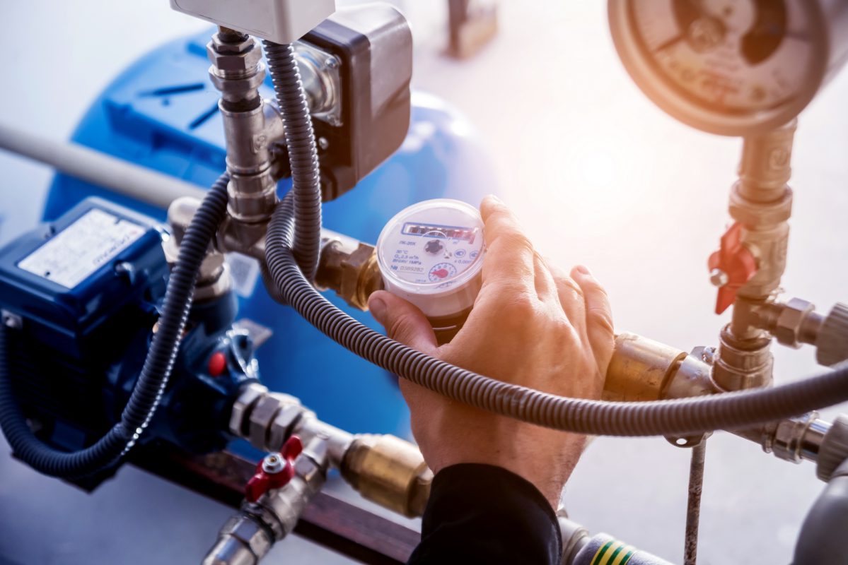 Technician checking water system nodes.Modern Industrial background